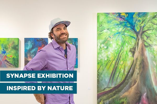 Bode Klein stands in front of his tree painting