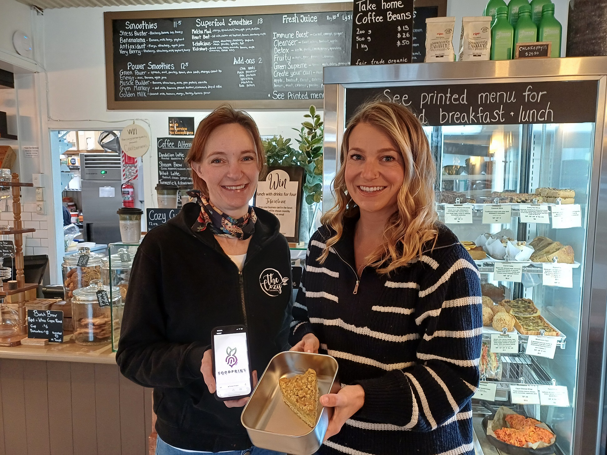 ​Camilla Baker and Shannon Hanson at the Cozy Corner Cafe, one of the Taupō District businesses who are part of Foodprint app.