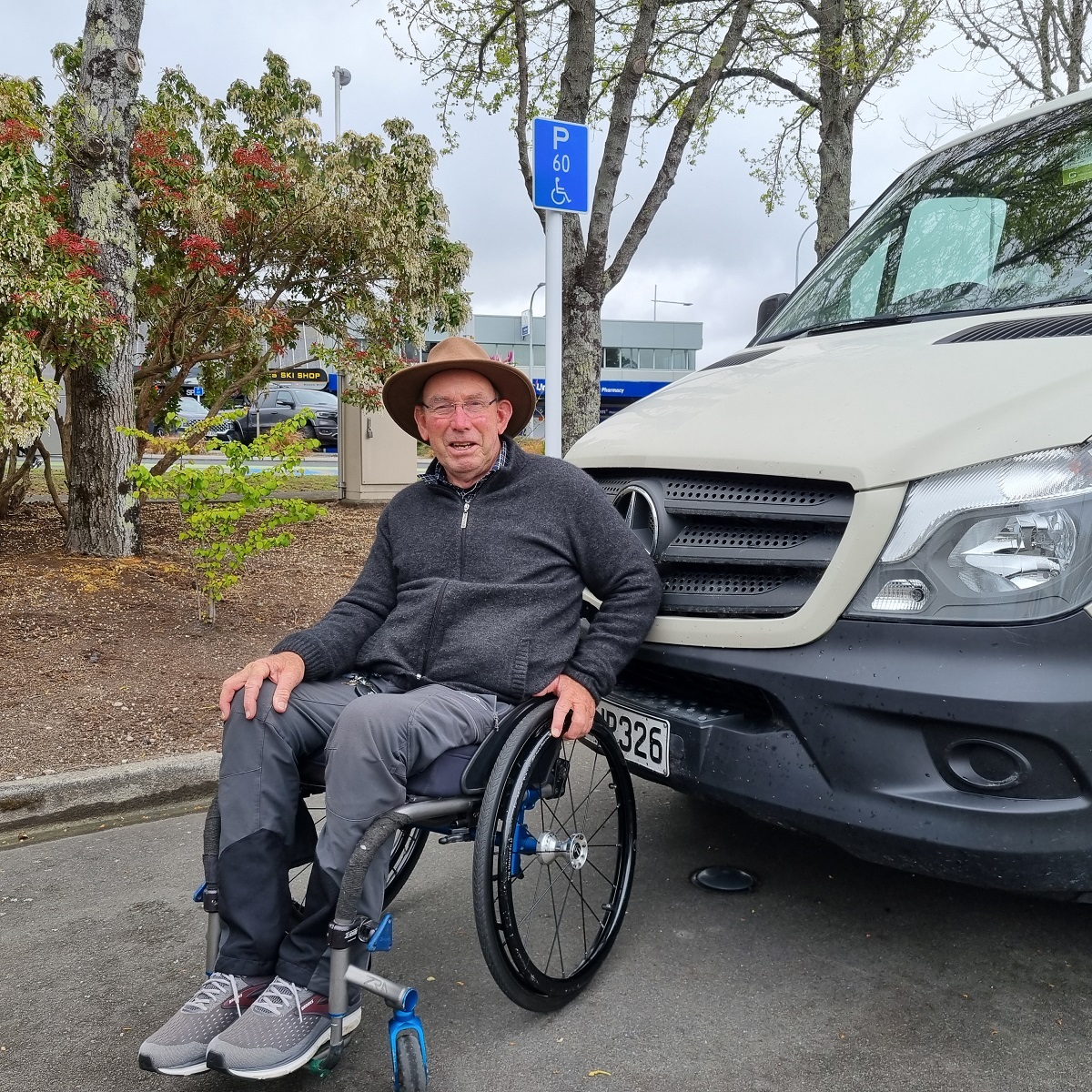 Cam in his wheelchair with his van.  