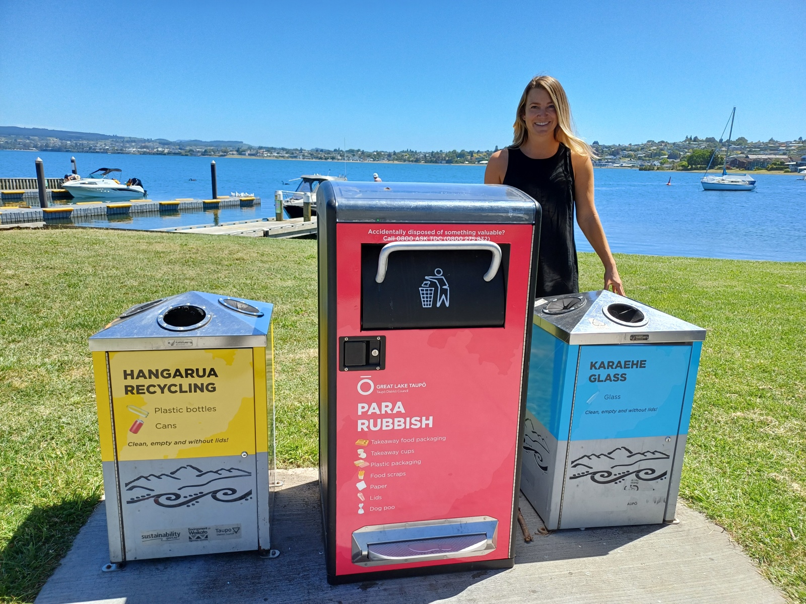 Shannon with new branded rubbish and recycling bins at Two Mile Bay.  